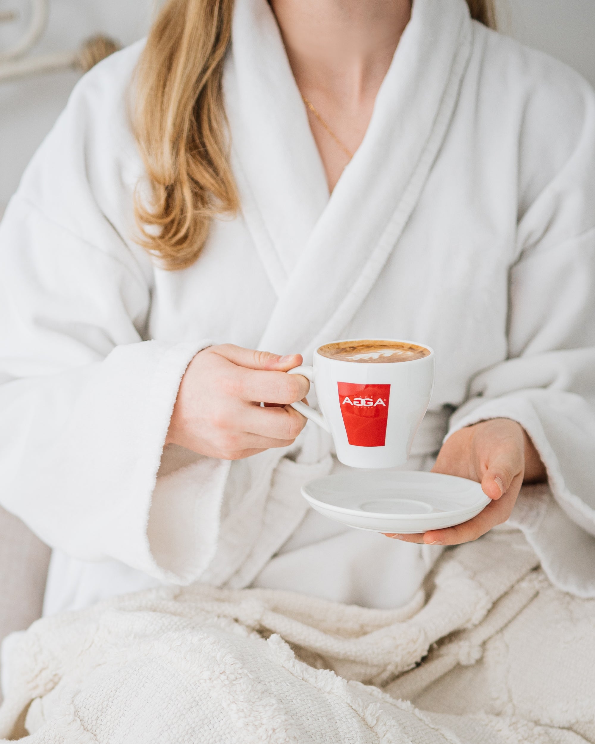 home page photo lady holding an agga up to drink in the morning  